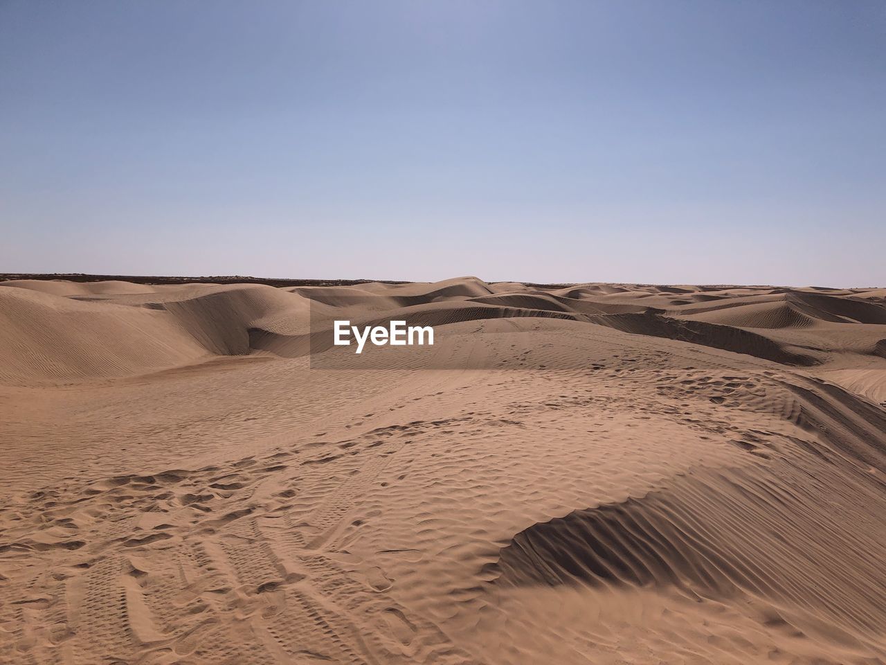 Scenic view of desert against clear sky