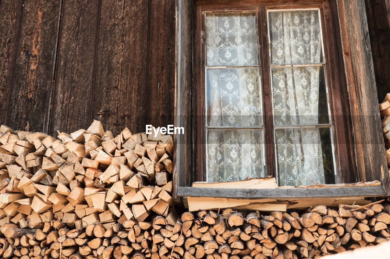 Heap of firewood by window