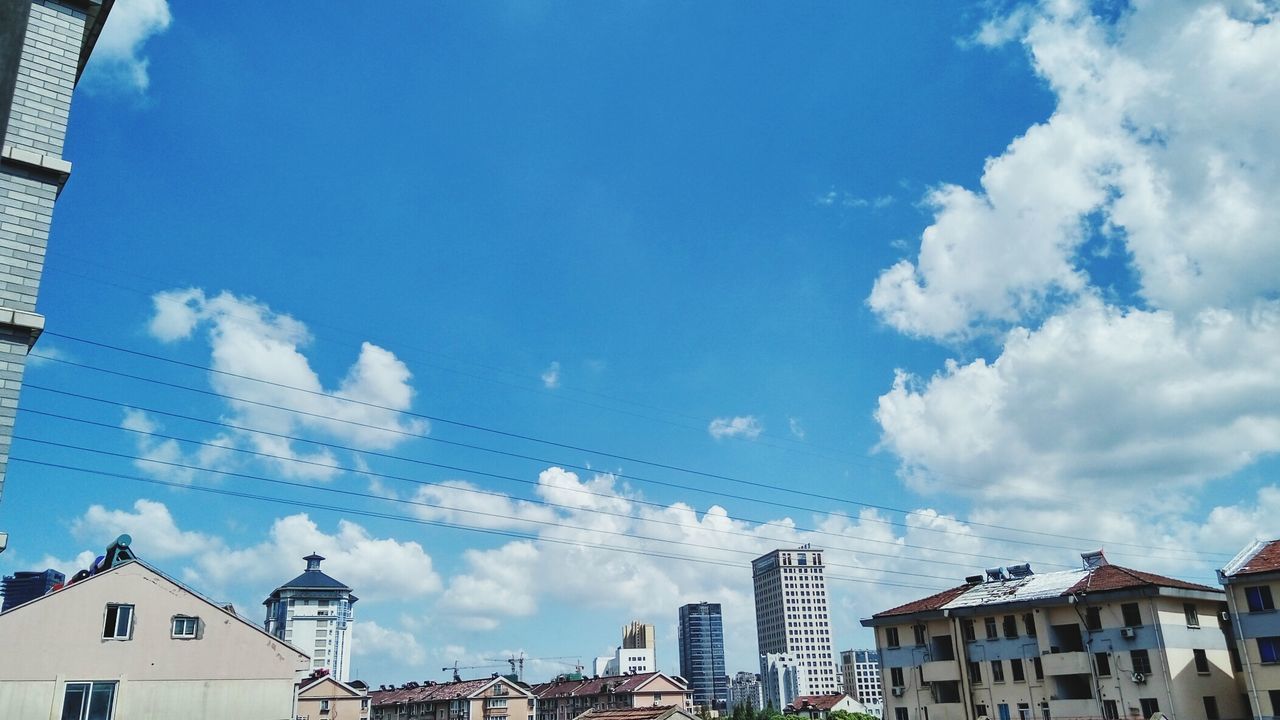 BUILDINGS AGAINST BLUE SKY