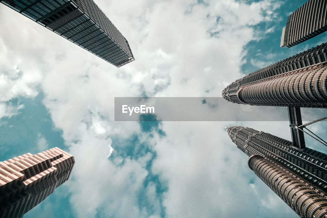 Directly below shot of buildings against sky