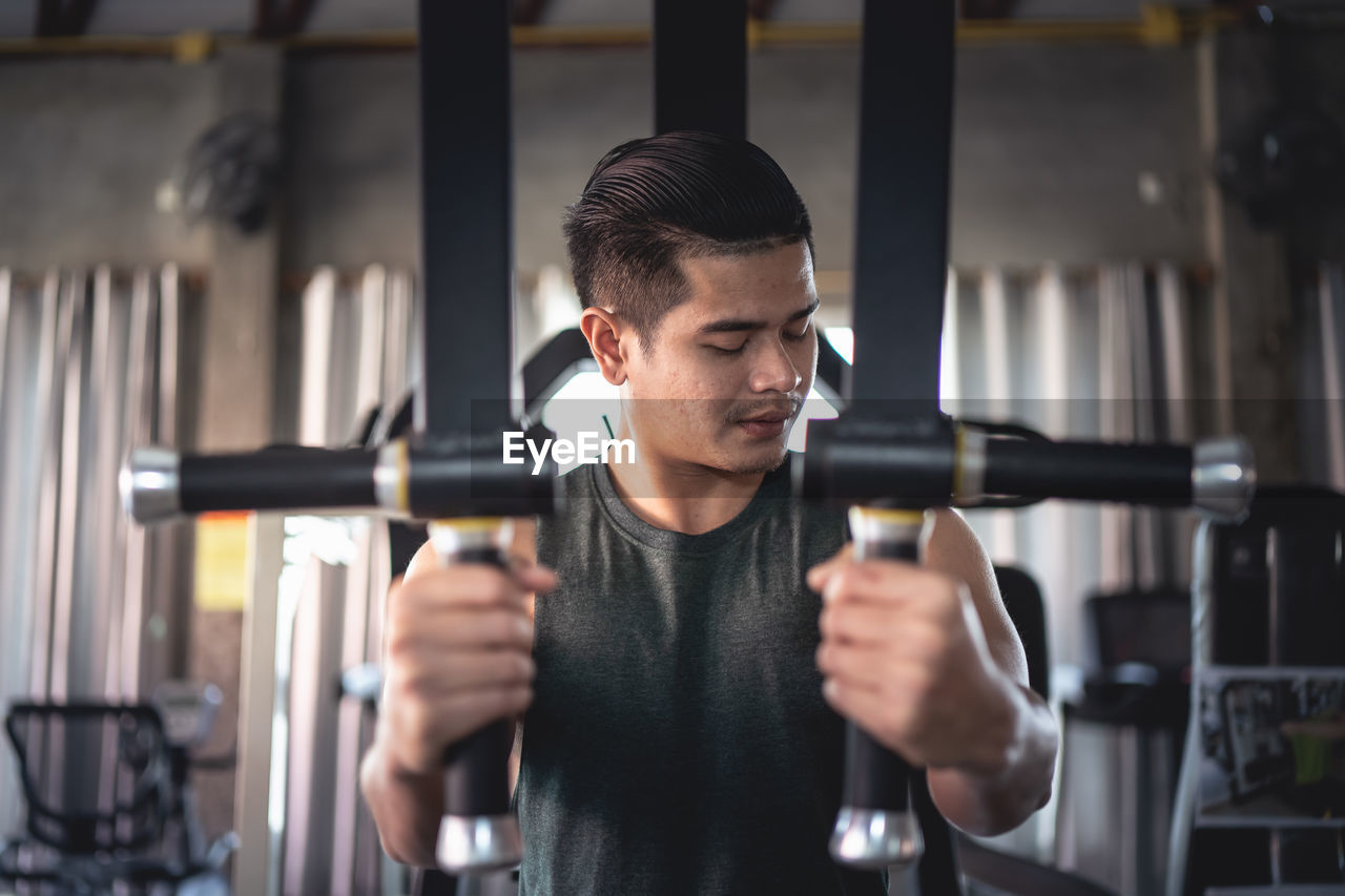 Young man exercising at gym