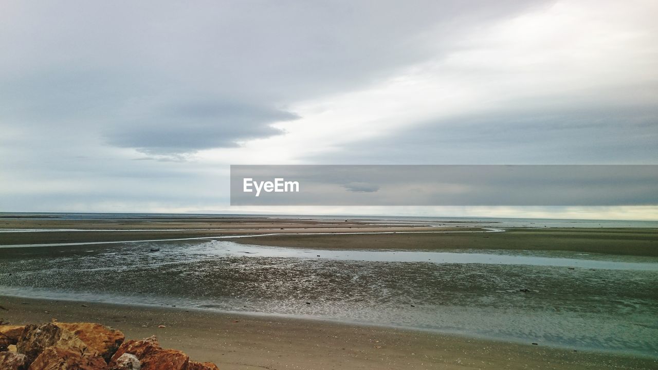 View of calm beach against the sky