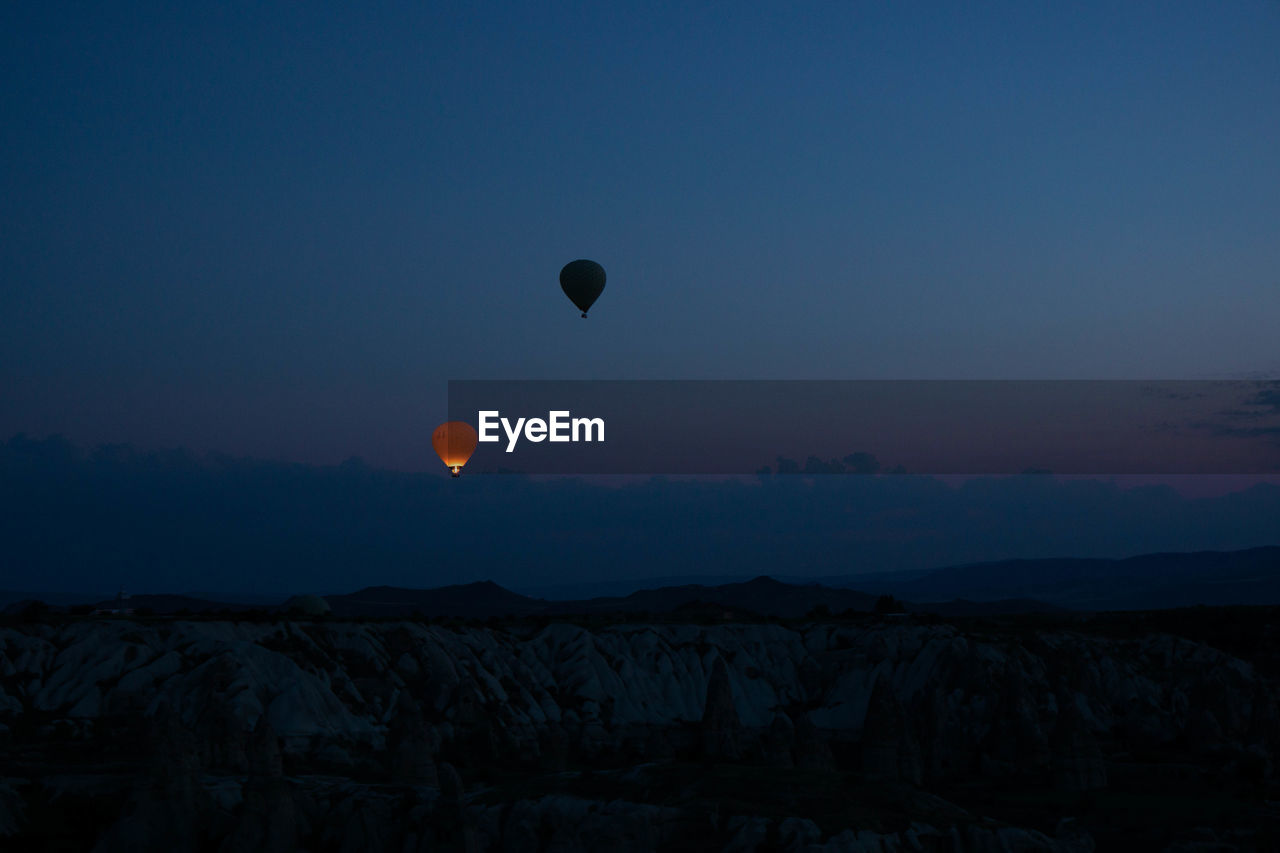 Hot air balloons against sky at sunset