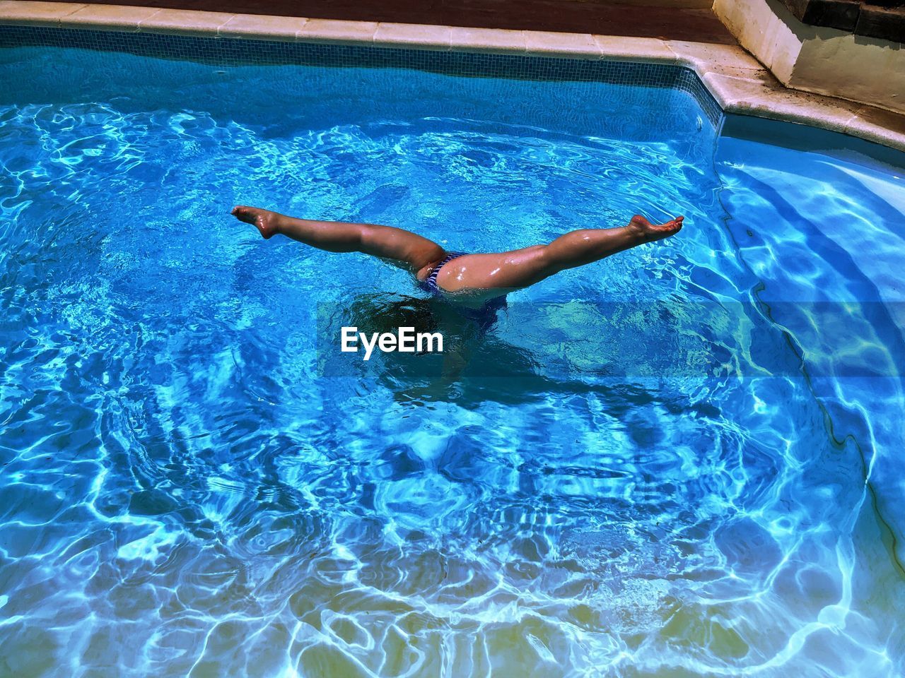 High angle view of woman swimming in pool