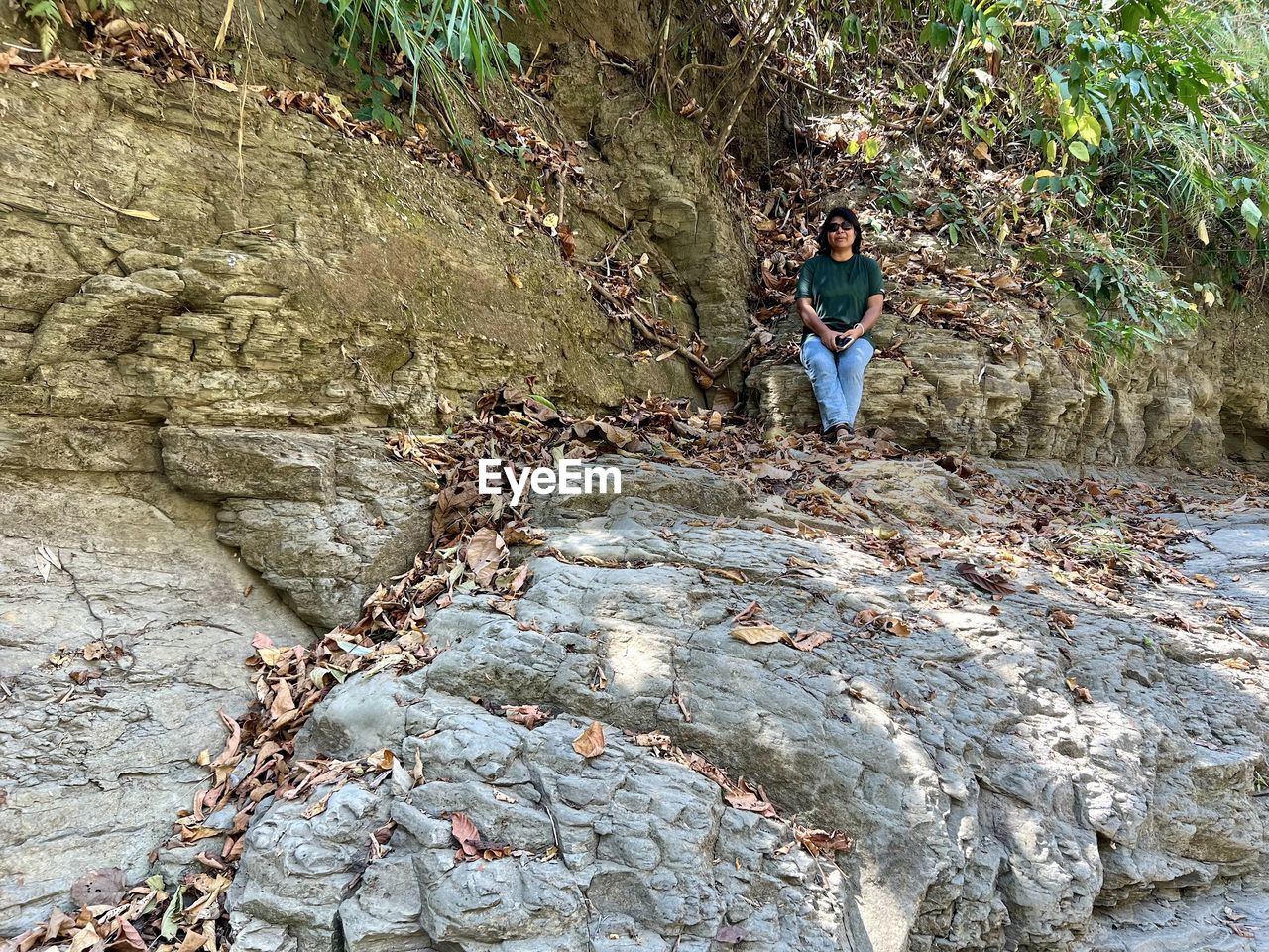 one person, leisure activity, rock, day, nature, full length, lifestyles, geology, tree, plant, men, land, outdoors, casual clothing, beauty in nature, standing, high angle view, activity, wilderness, forest, trail, non-urban scene, adult, women, tranquility, hiking, adventure, rock formation, young adult