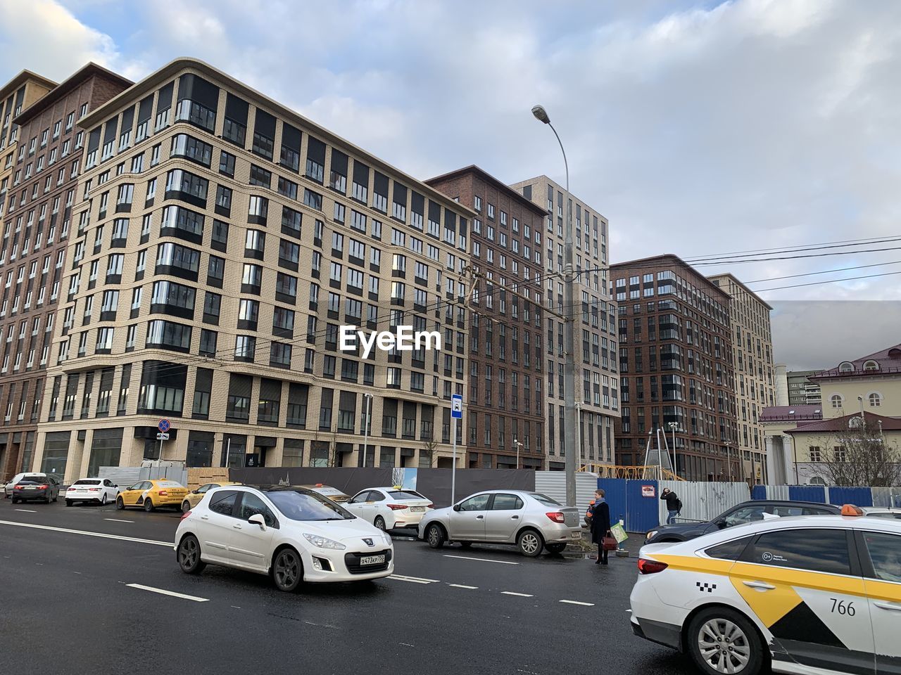 Traffic on road against buildings in city