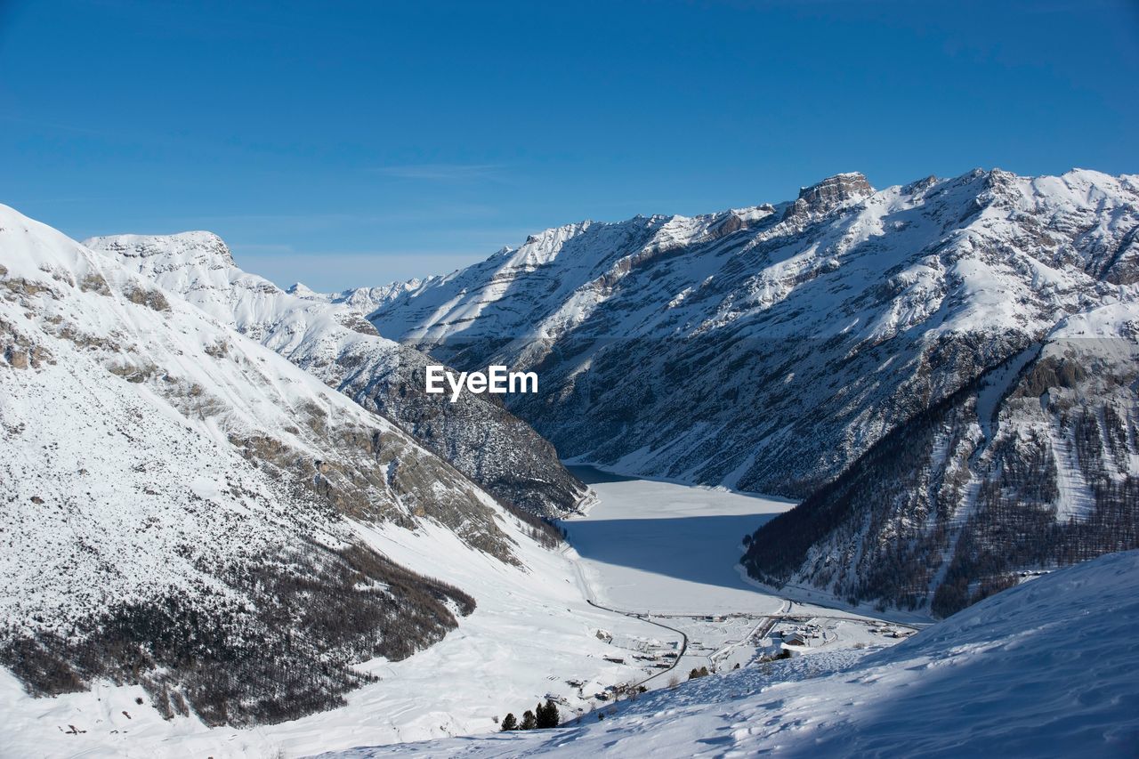 Scenic view of snowcapped mountains against sky