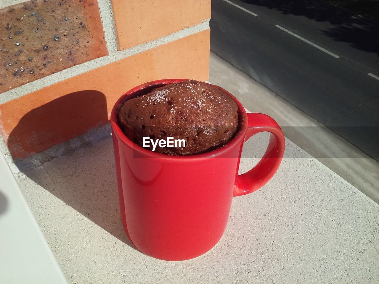 High angle view of cake in mug by road