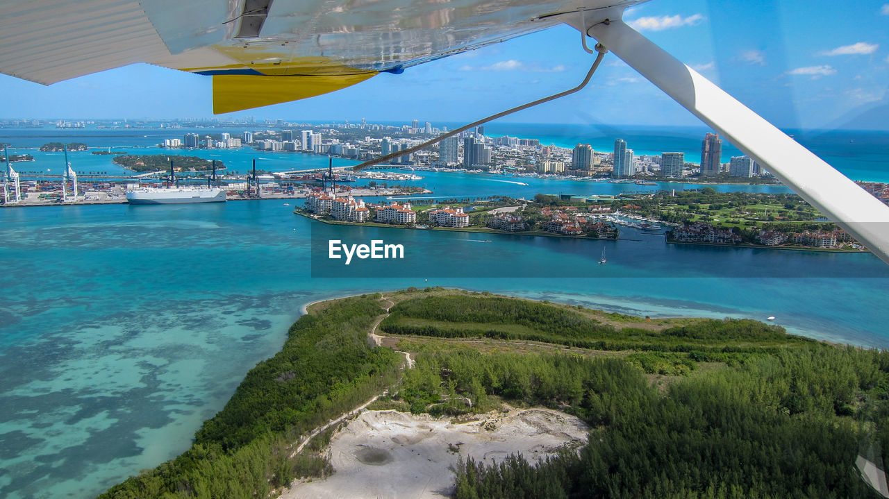 Aerial view from a seaplane of virginia key, fisher island, and south beach in miami, florida.
