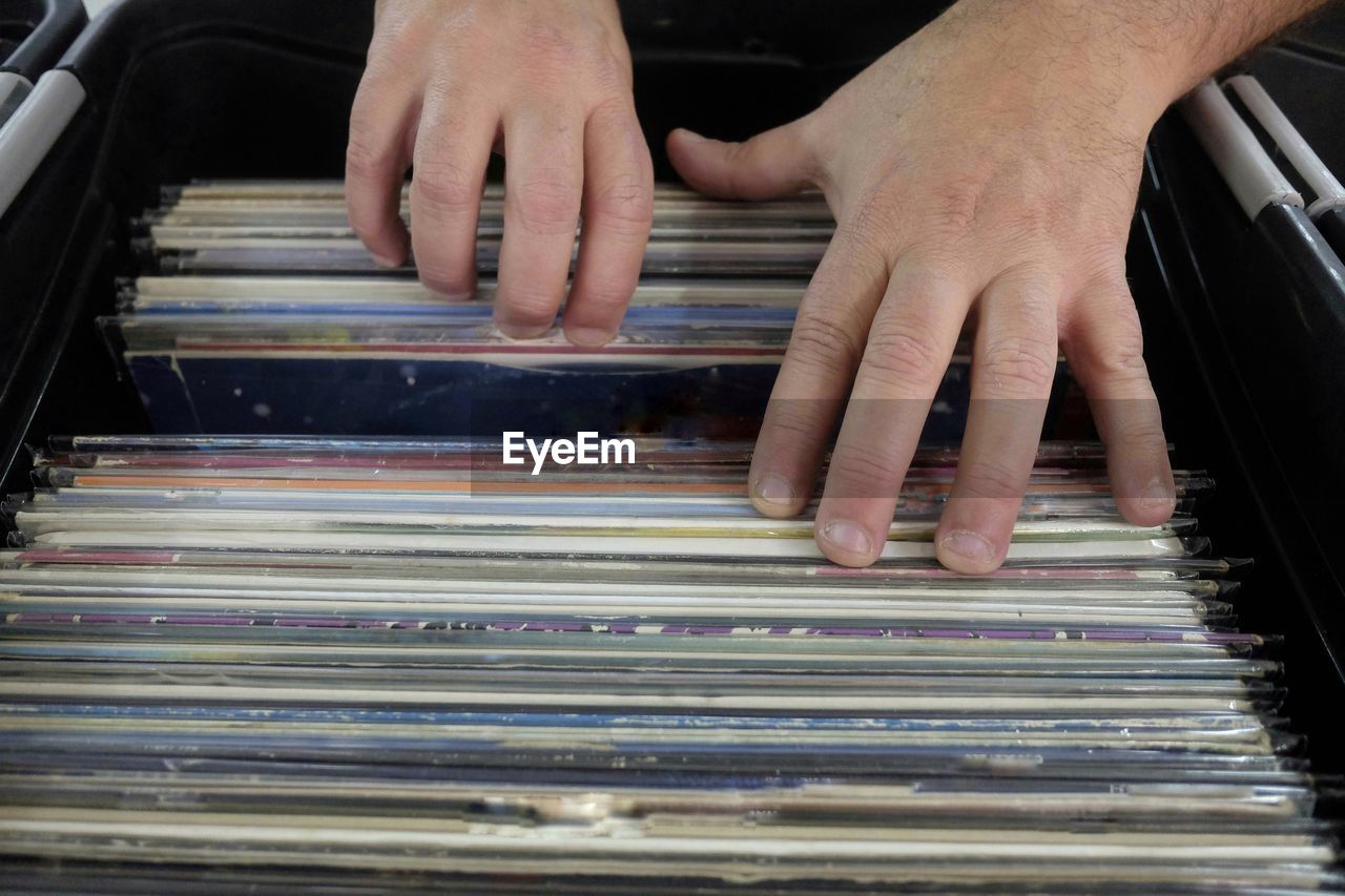 Cropped hands of man searching records