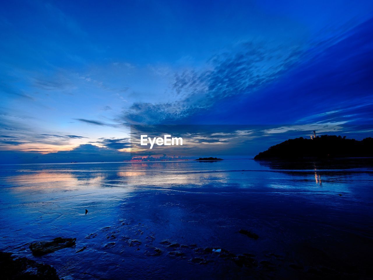 Scenic view of sea against blue sky