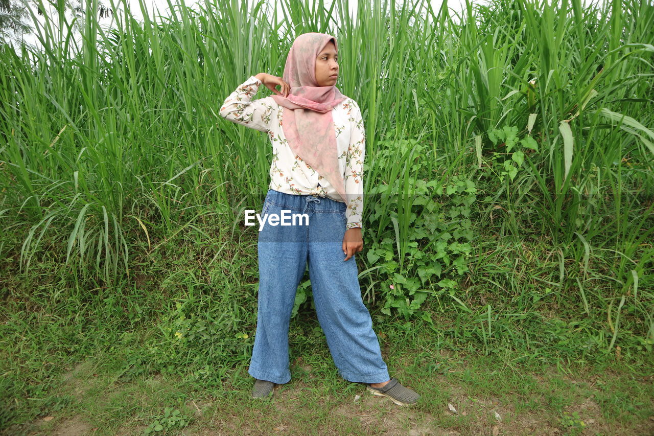 Full length of woman standing in farm