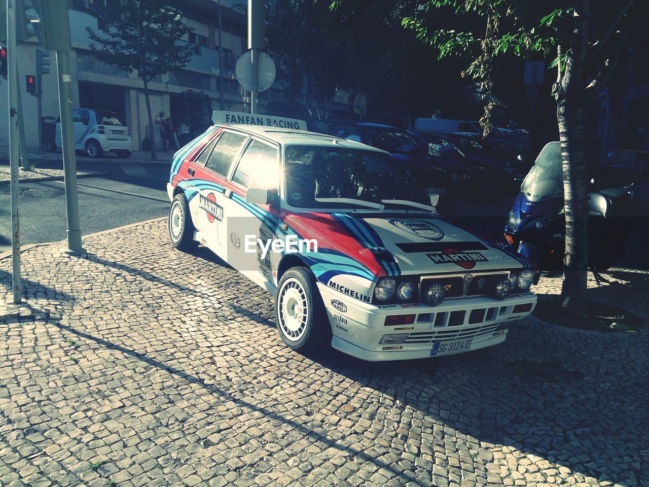 CLOSE-UP OF CAR ON STREET