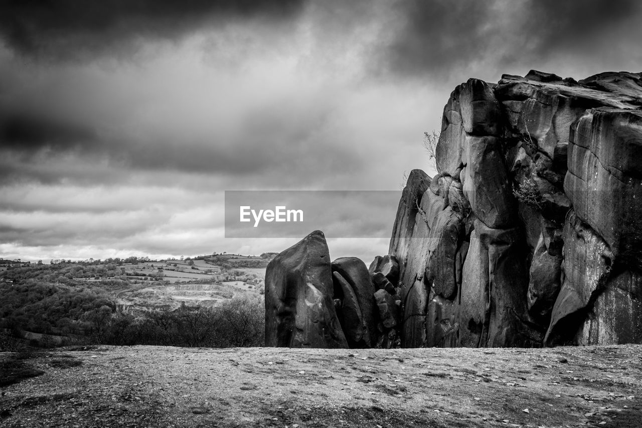 Panoramic view of rocks on field against sky