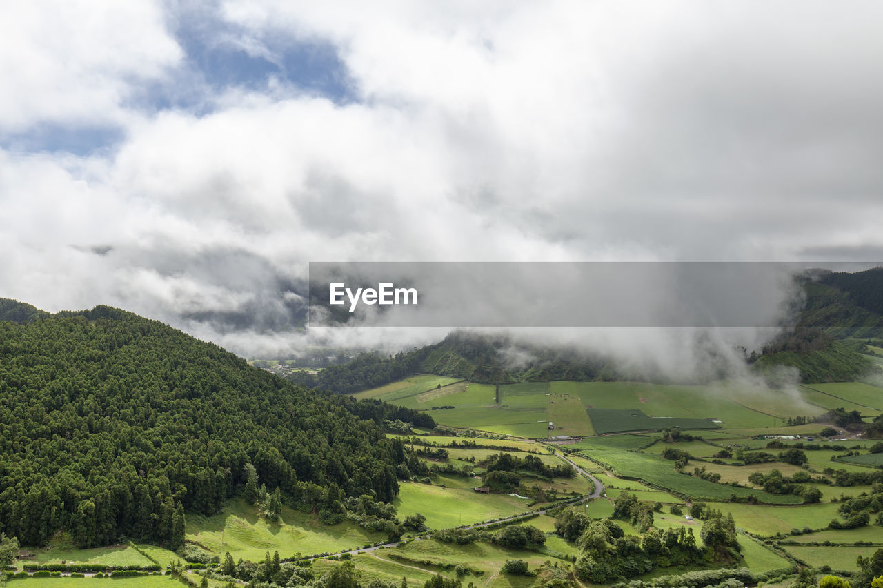 SCENIC VIEW OF FARMS AGAINST SKY