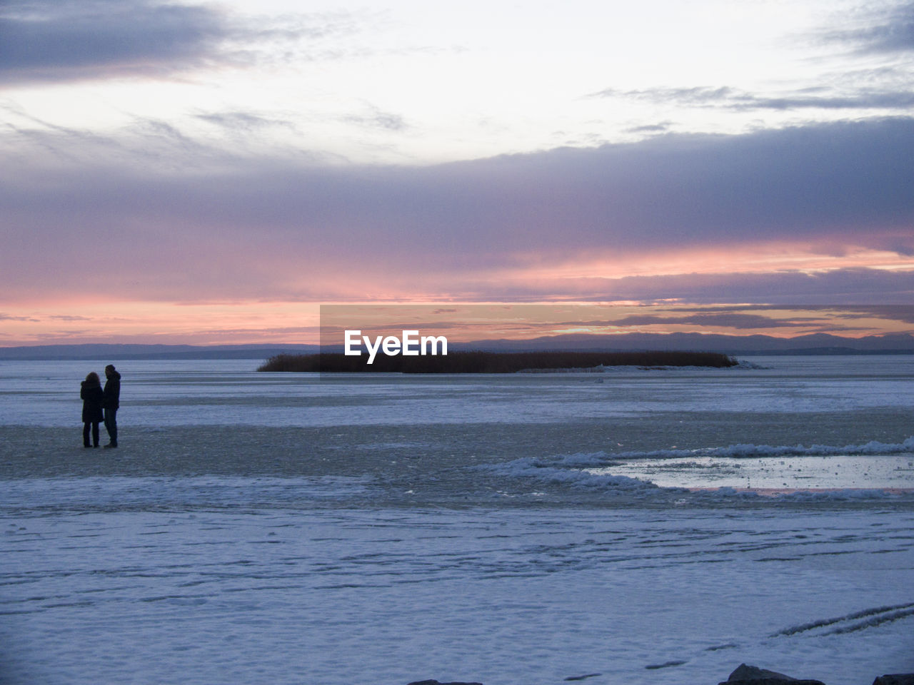 Scenic view of frozen sea at sunset