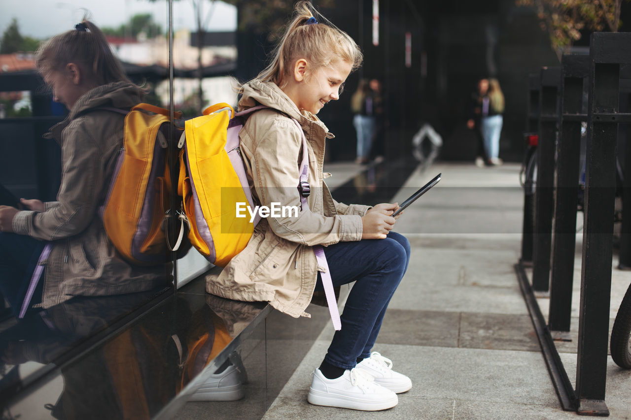 Girl using tablet in city