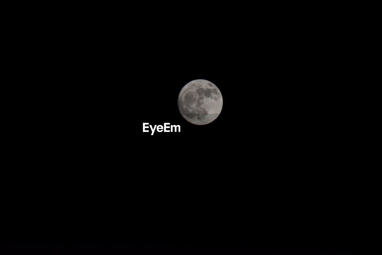 Low angle view of moon against clear sky at night