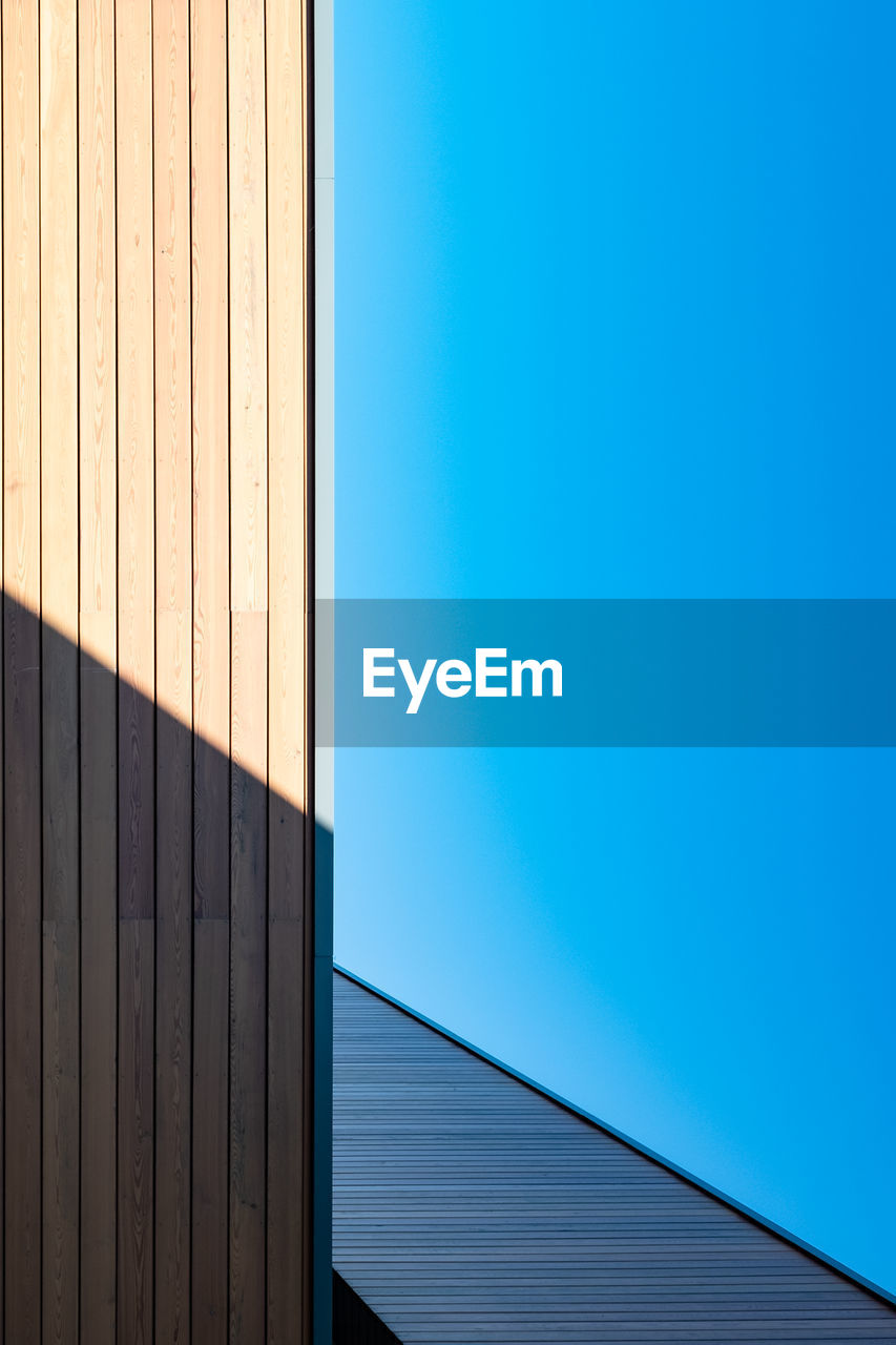 Low angle view of building against clear blue sky