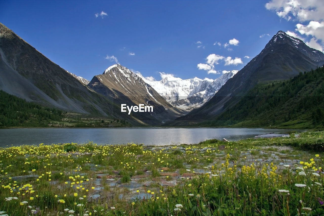 Idyllic shot of lake and mountains against sky