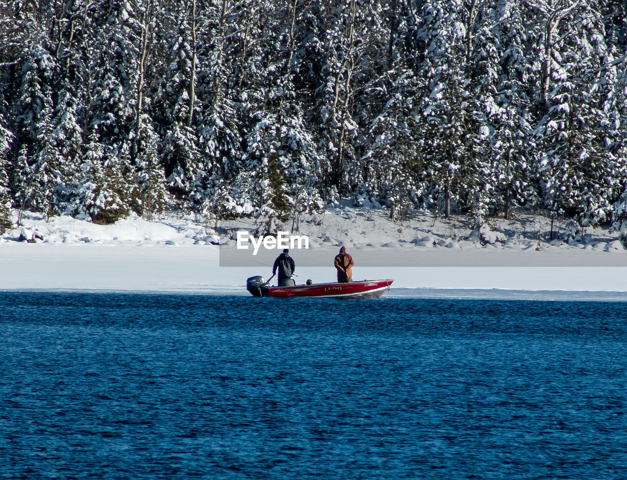 Two fisherman on boat in winter