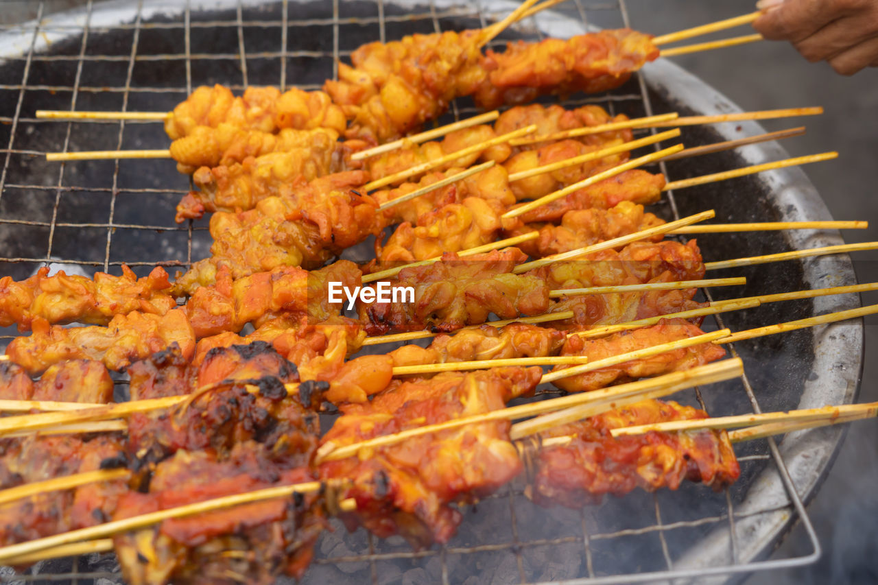 cropped image of meat cooking on barbecue grill