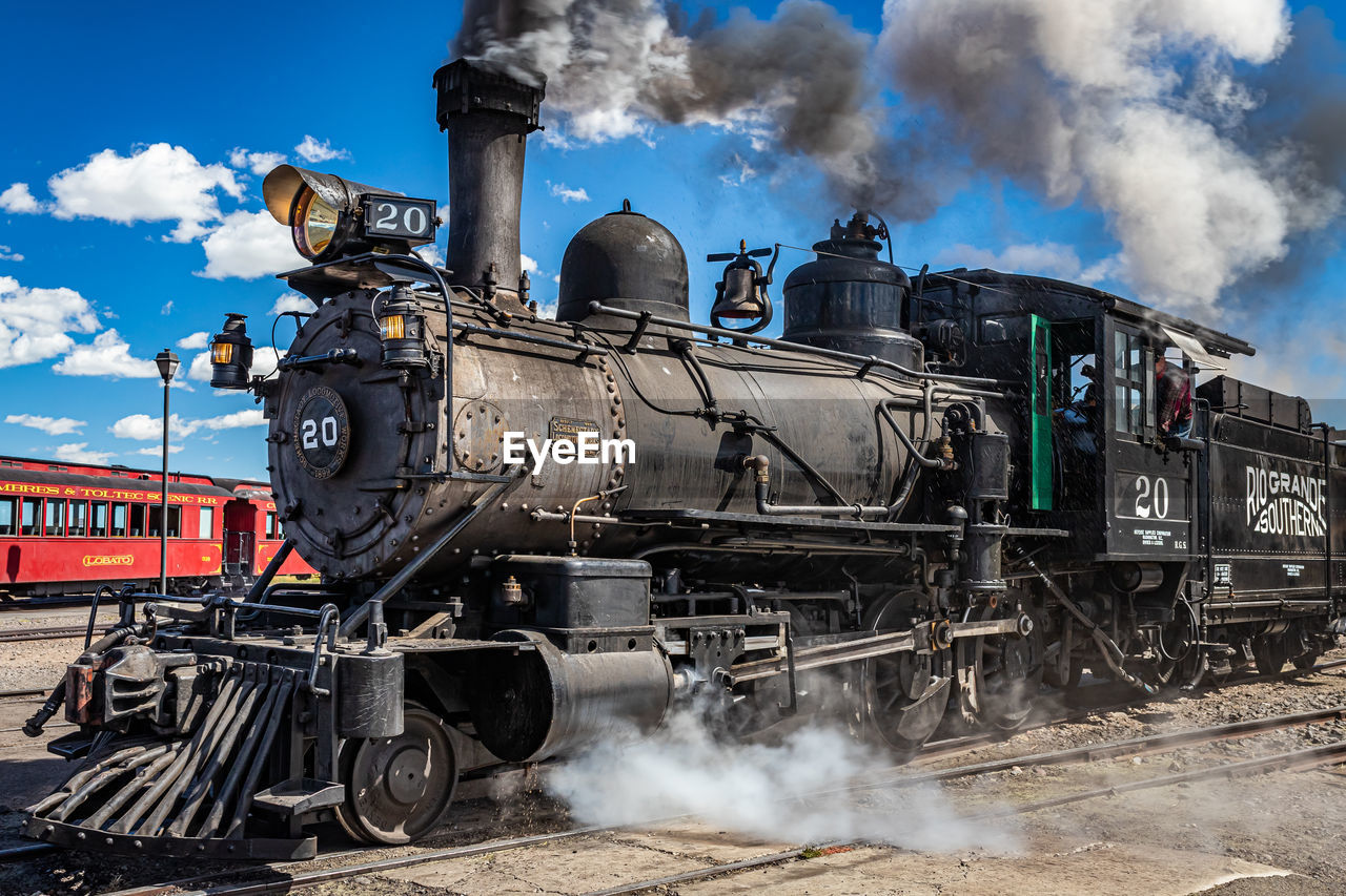 rail transportation, train, locomotive, steam train, transportation, smoke, mode of transportation, railway, transport, steam engine, track, railroad track, vehicle, sky, land vehicle, steam, cloud, nature, public transportation, no people, day, engine, auto part, outdoors, motion, wheel