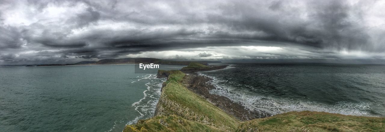 PANORAMIC SHOT OF SEA AGAINST STORM CLOUDS