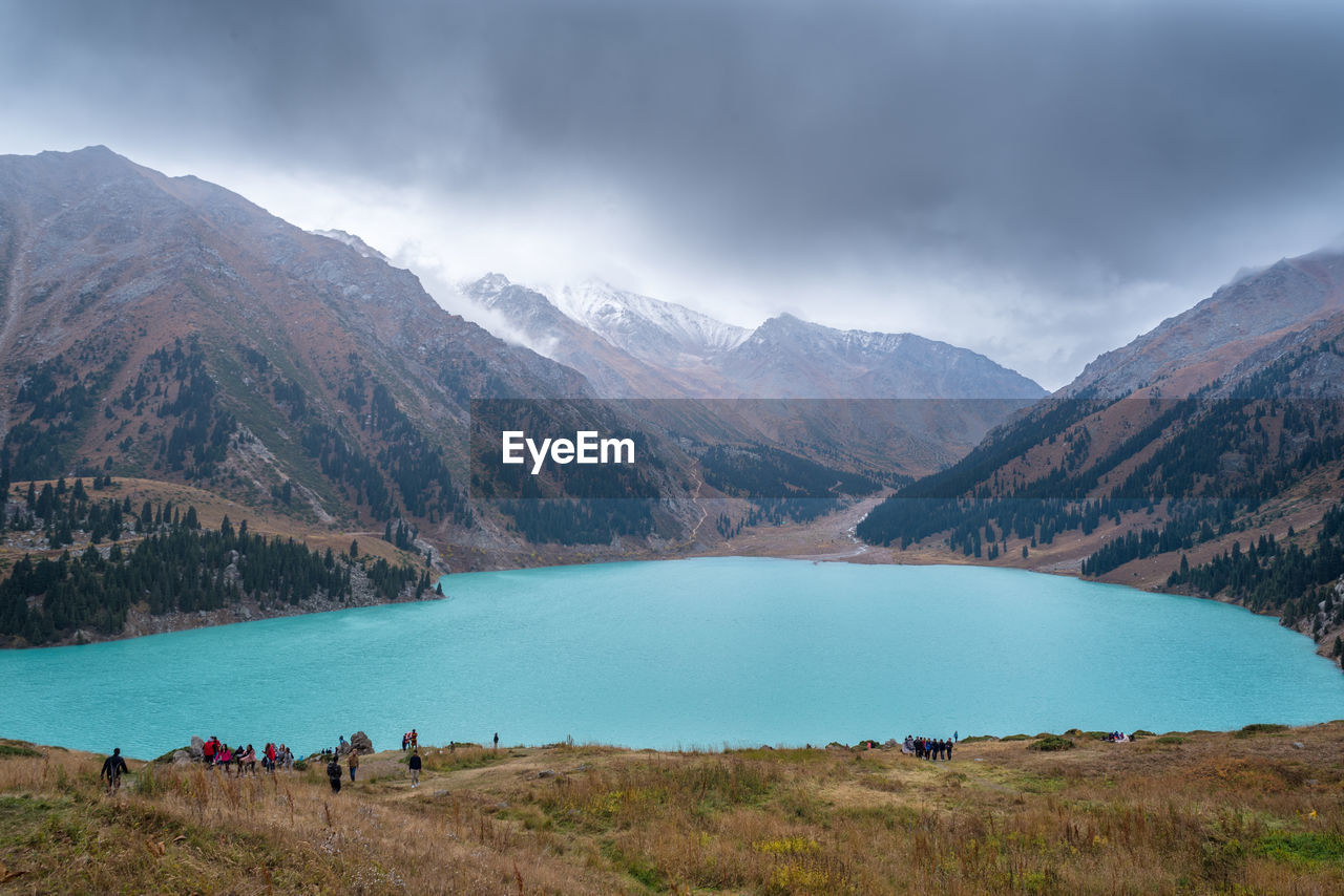 Scenic view of lake and mountains against sky