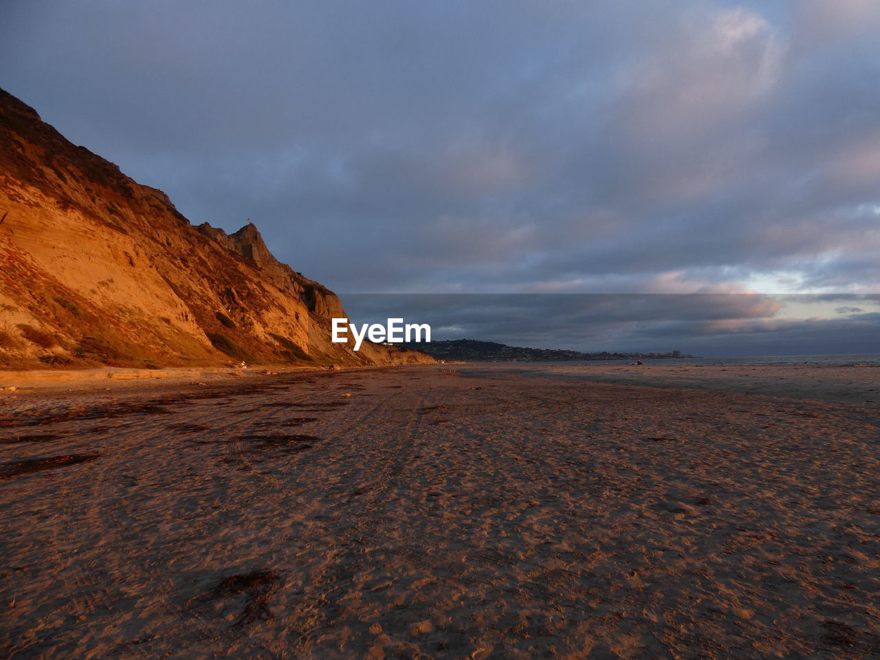 Scenic view of desert against sky during sunset