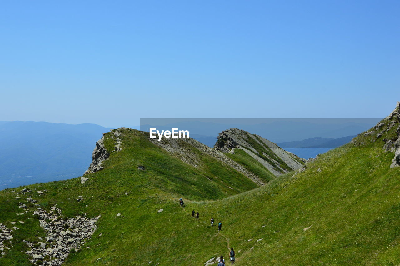 Scenic view of mountains against clear blue sky