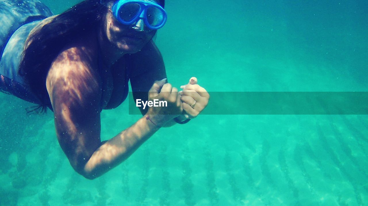 MAN SWIMMING IN SEA