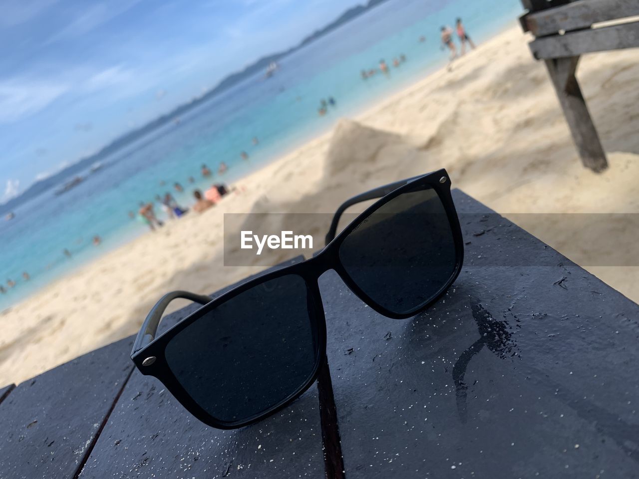 close-up of sunglasses on sand at beach