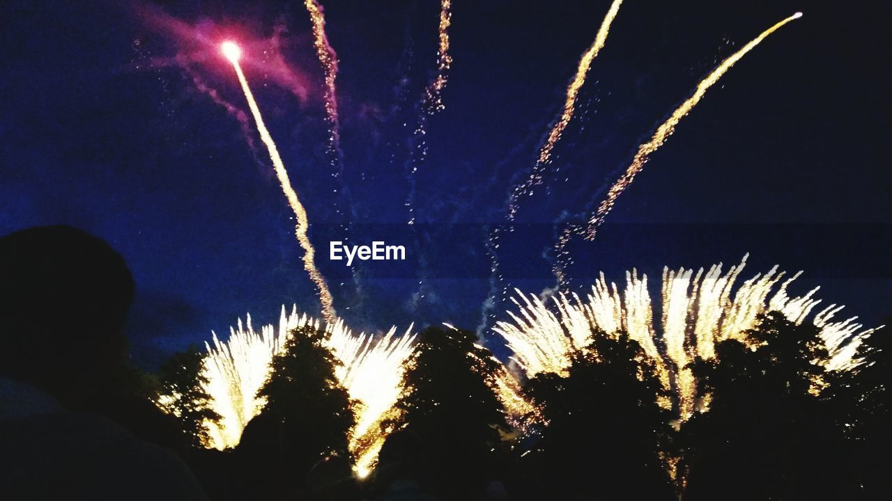 LOW ANGLE VIEW OF FIREWORKS DISPLAY