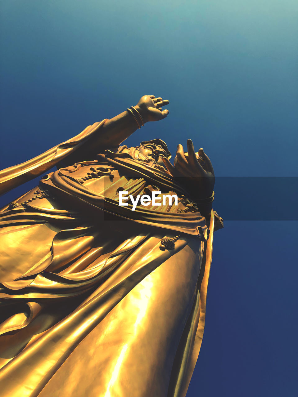 Low angle view of statue against clear blue sky