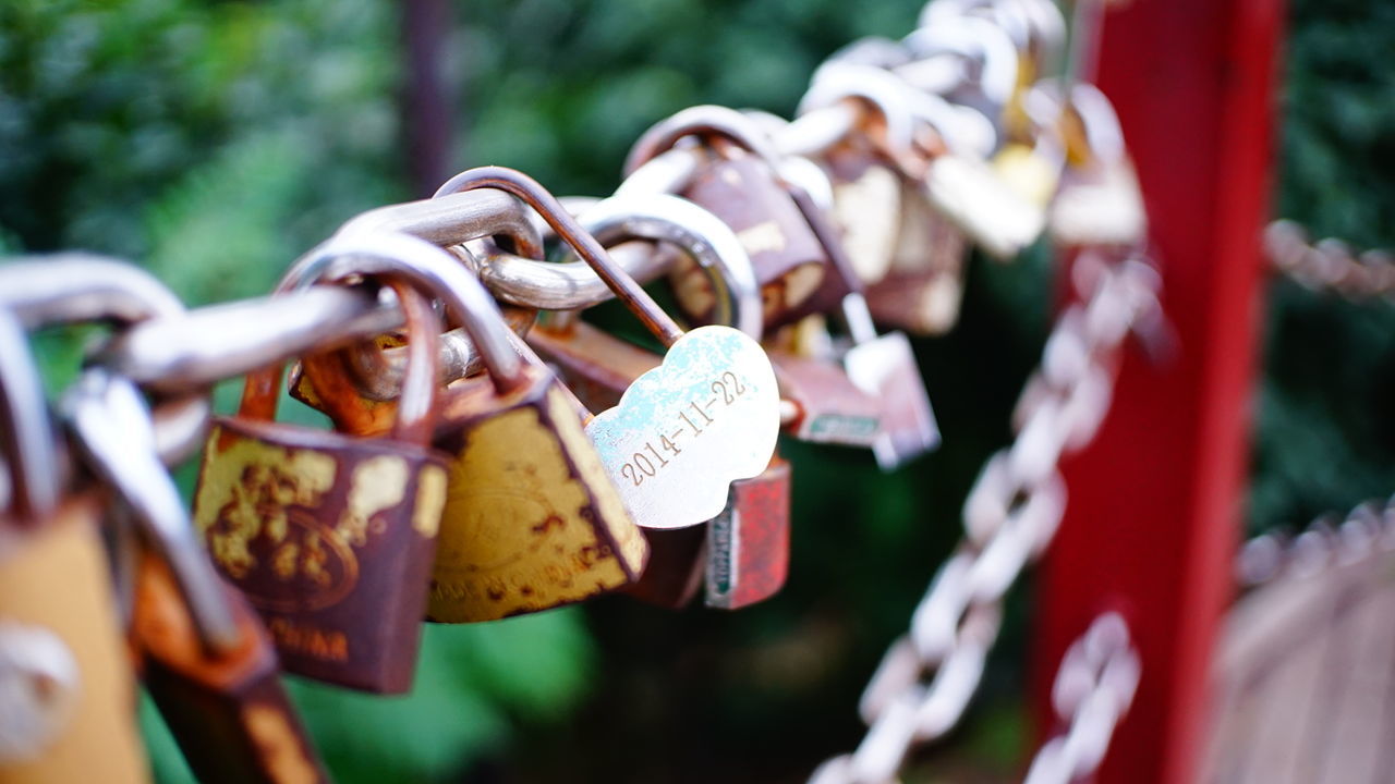 Close-up of padlocks hanging on railing