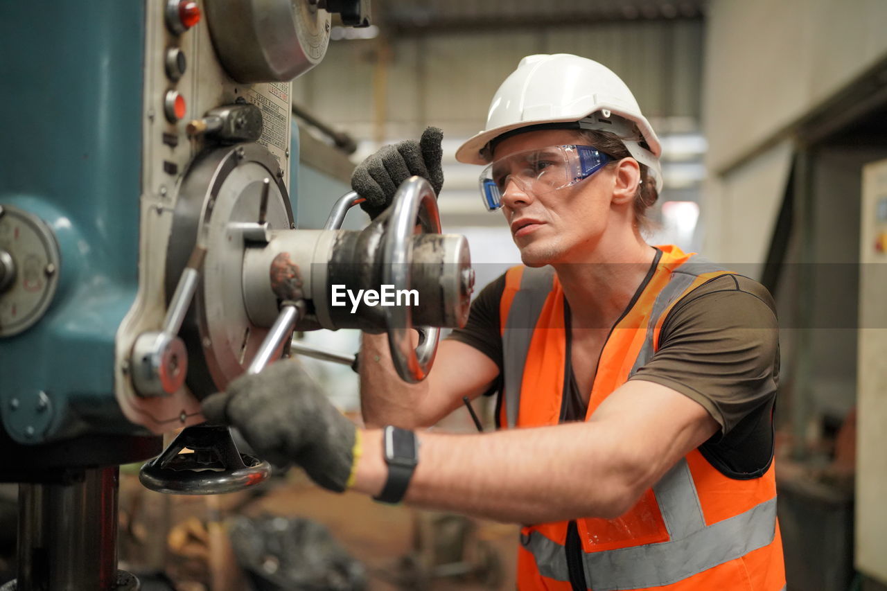 side view of man working in factory