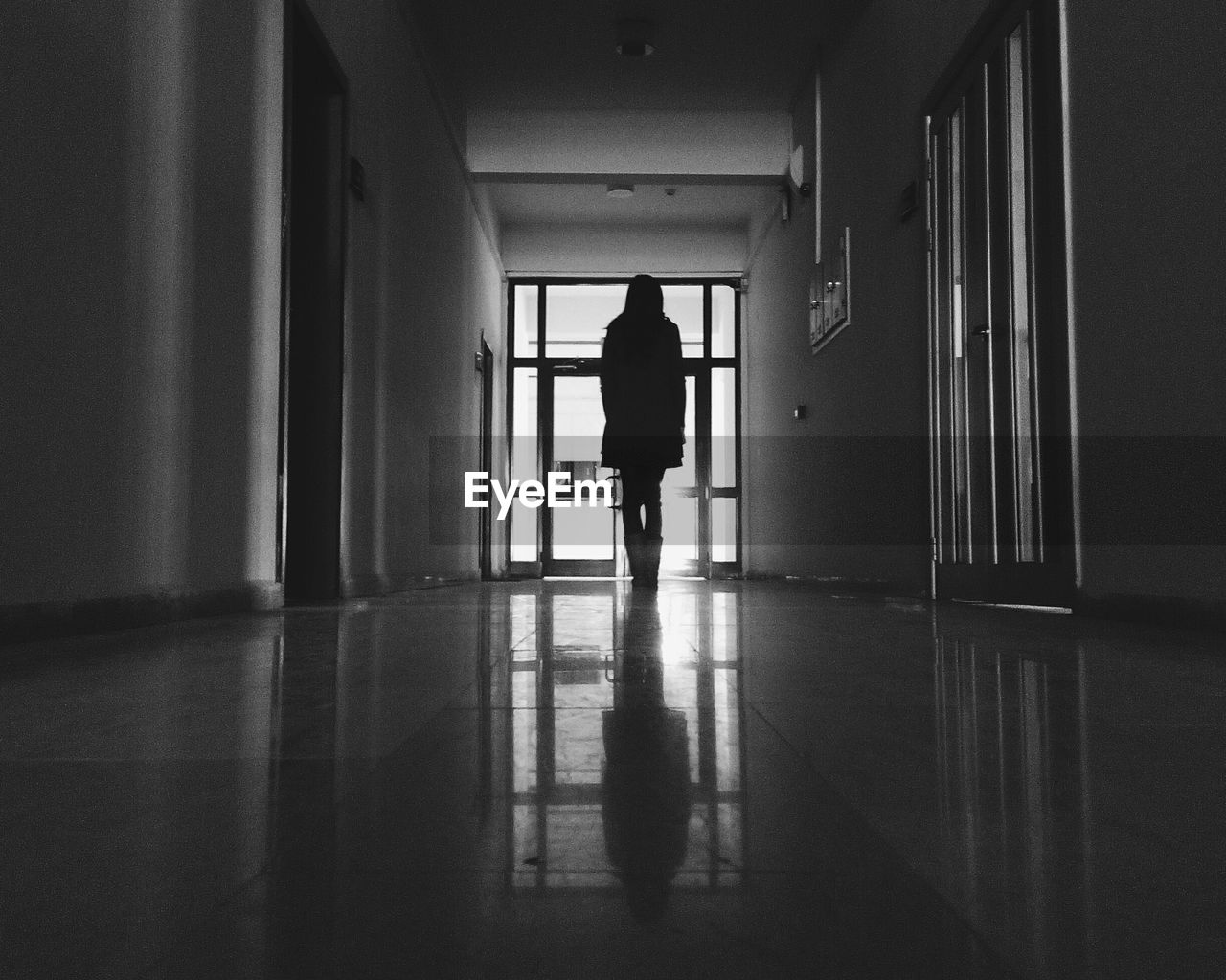 WOMAN WALKING IN CORRIDOR