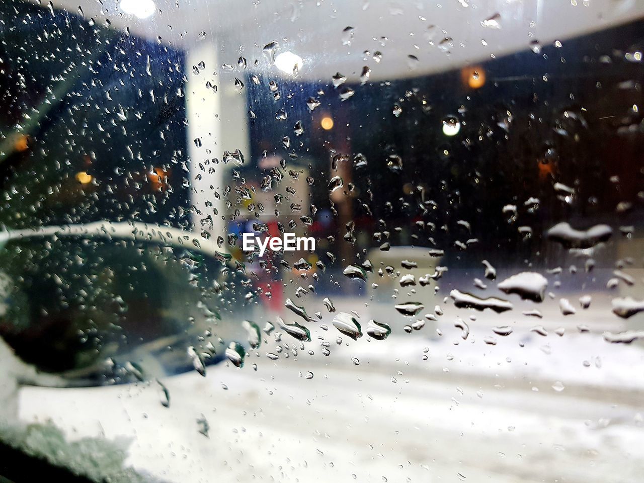 CLOSE-UP OF RAINDROPS ON WINDOW GLASS