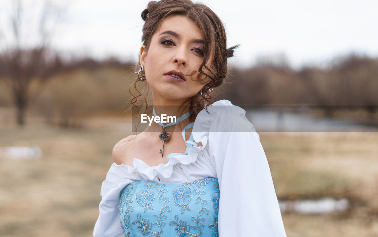 Portrait of woman against sky