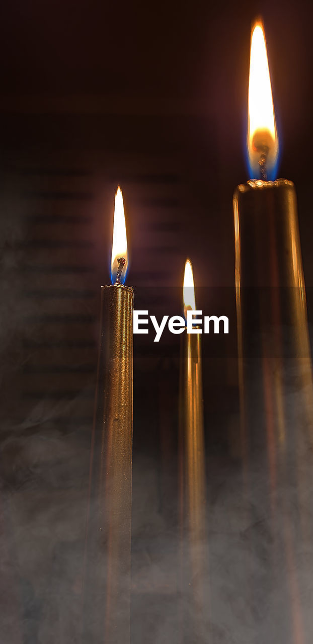 Close-up of illuminated candles on table