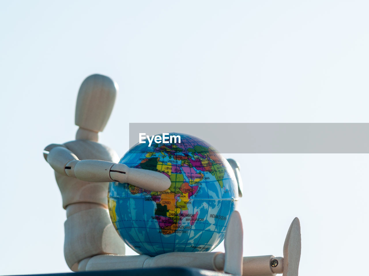 LOW ANGLE VIEW OF FIGURINE AGAINST CLEAR SKY