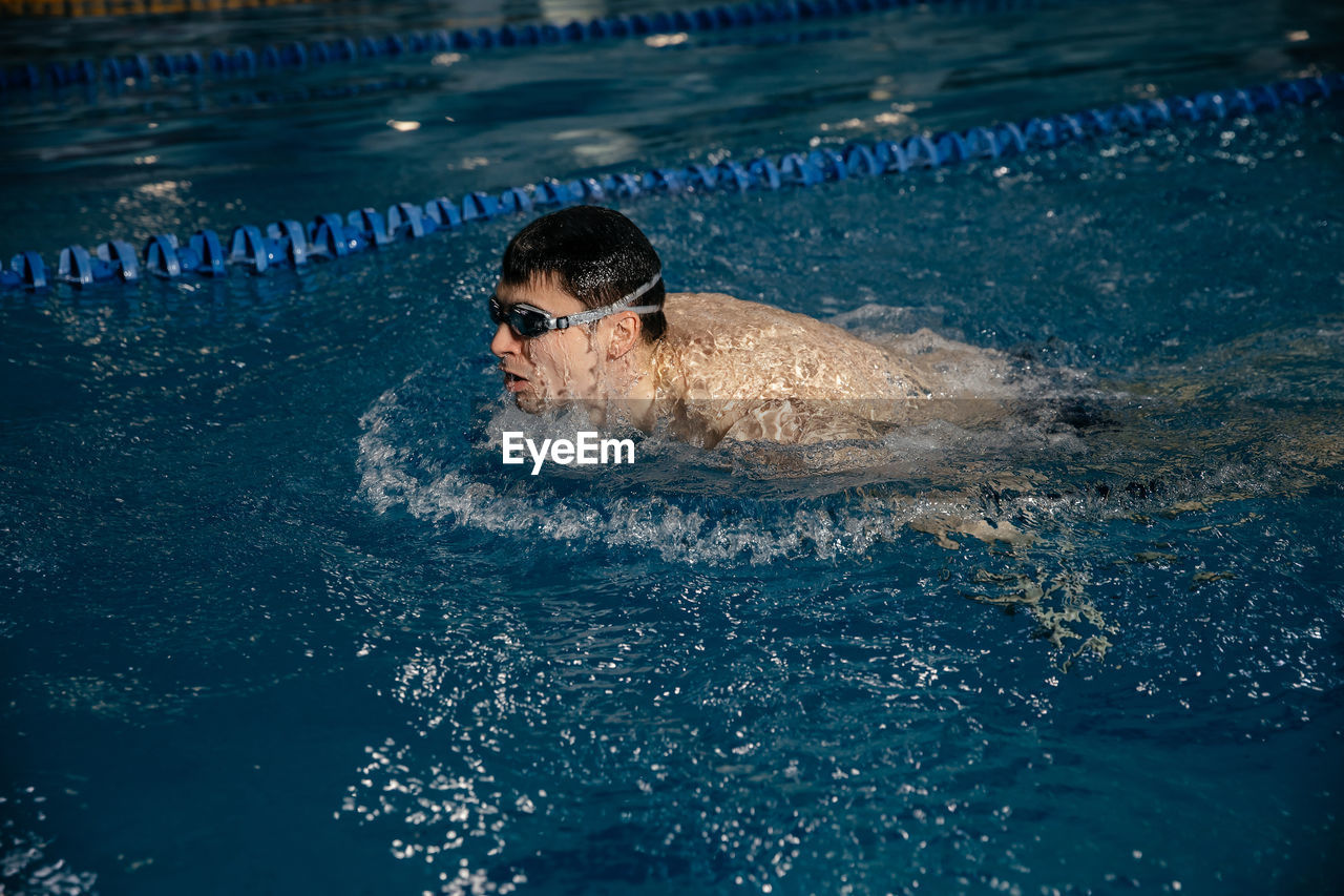 Man swimming in pool