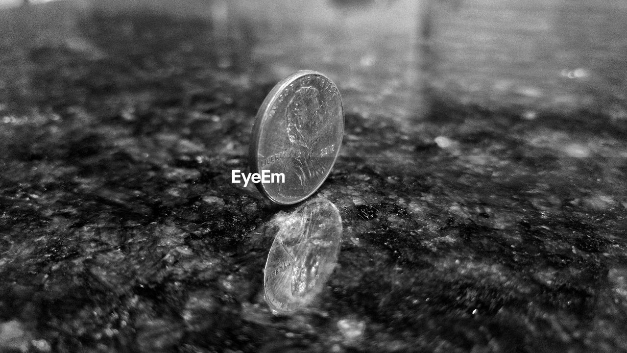 Close-up of coin on tiled floor