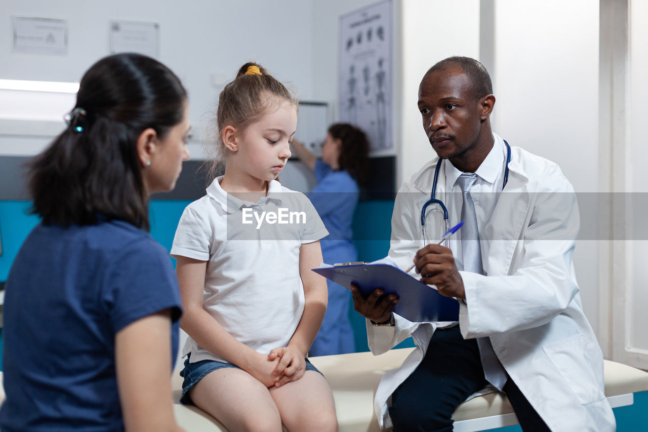 Doctor examining patient in clinic