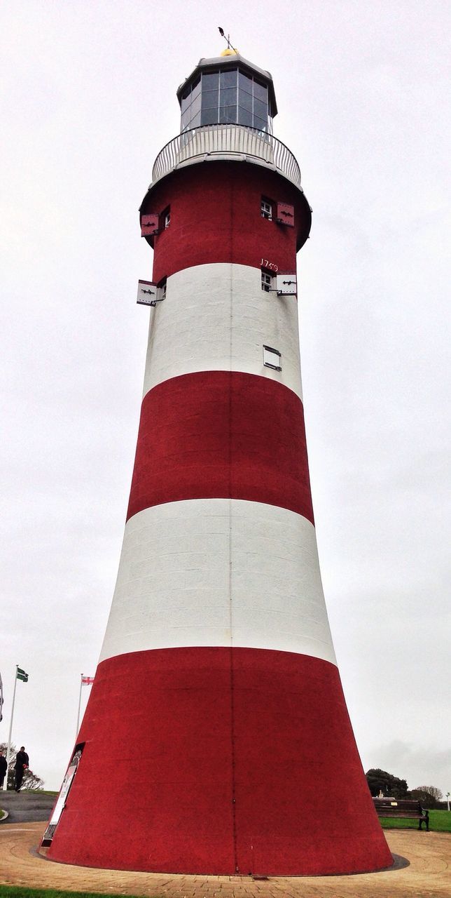 Striped lighthouse against sky