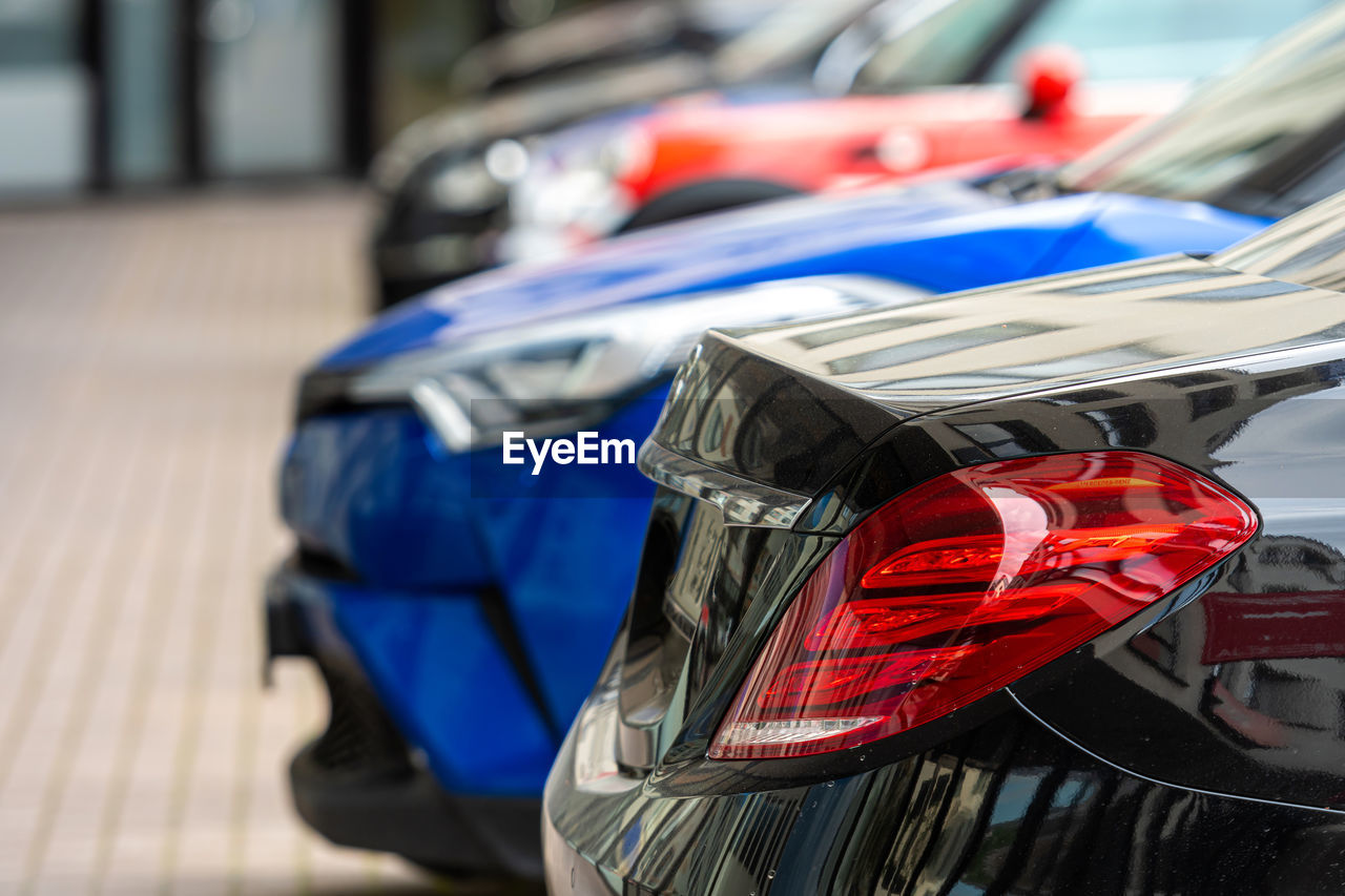 Close-up of the back of a row of cars parked at a business center