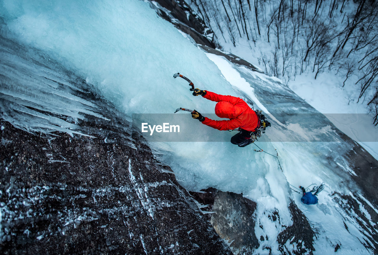 Man ice climbing on cathedral ledge in north conway, new hampshire