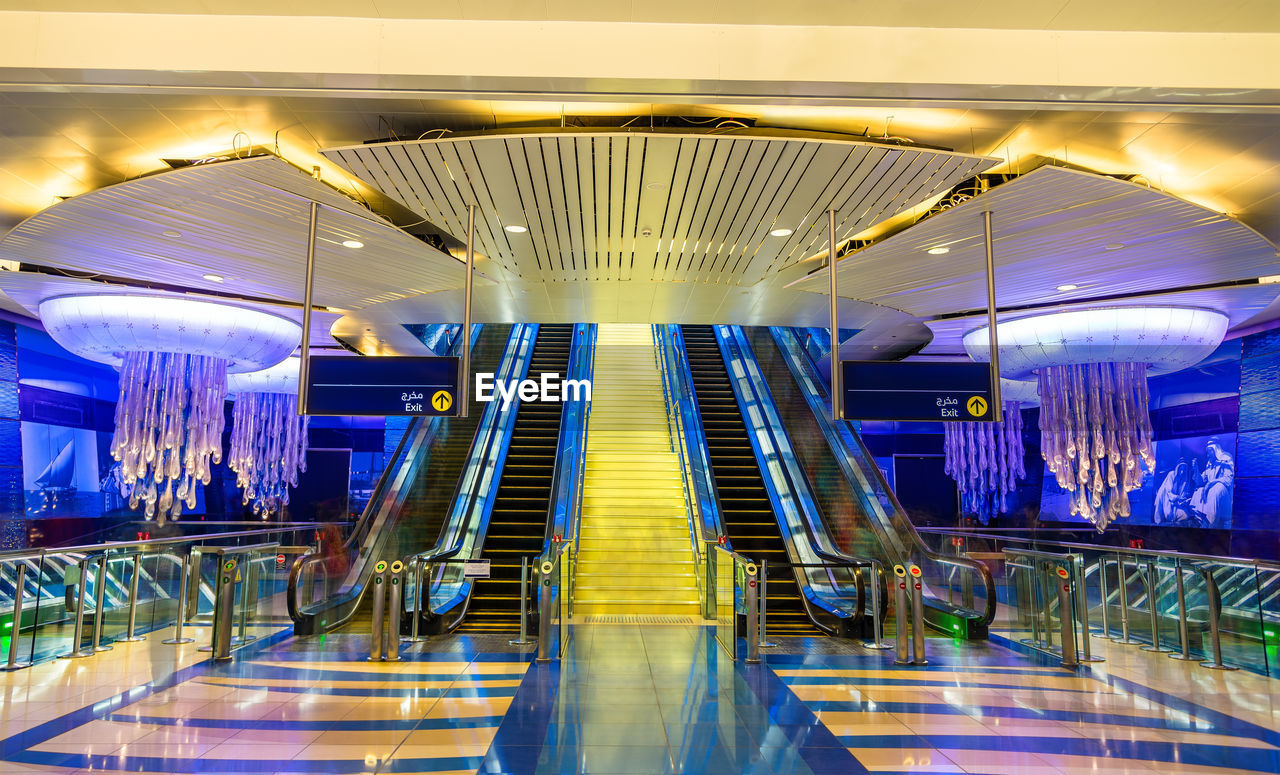 LOW ANGLE VIEW OF ESCALATORS IN SUBWAY STATION