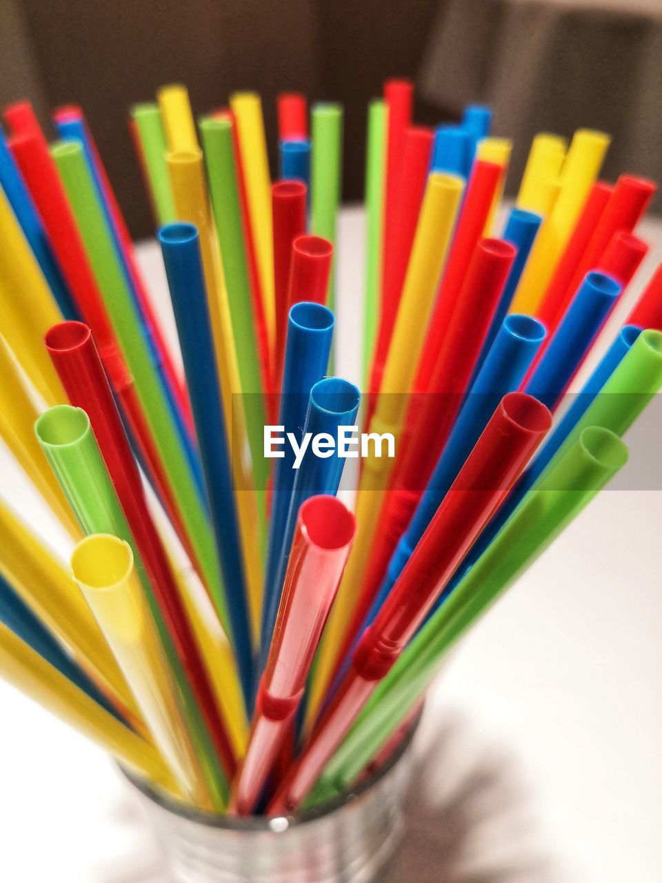 Close-up of multi colored drinking straws on table